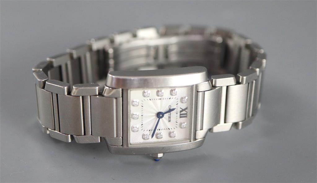 A ladys modern stainless steel Cartier Tank quartz wrist watch with diamond set numerals,
